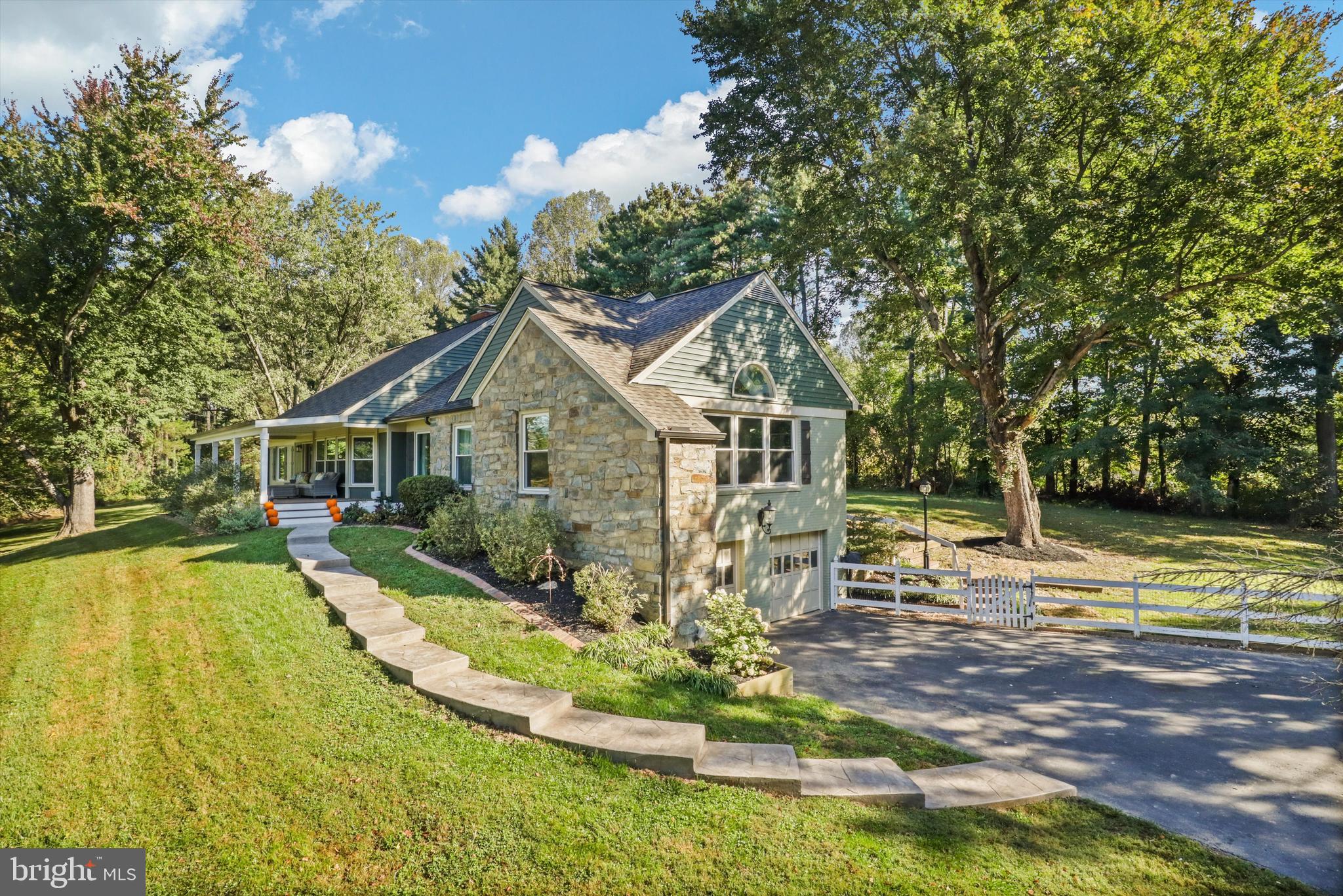 6811 White Rock Road Clifton, VA 20124 - Photo 12 of 87 a front view of a house with a yard table and chairs