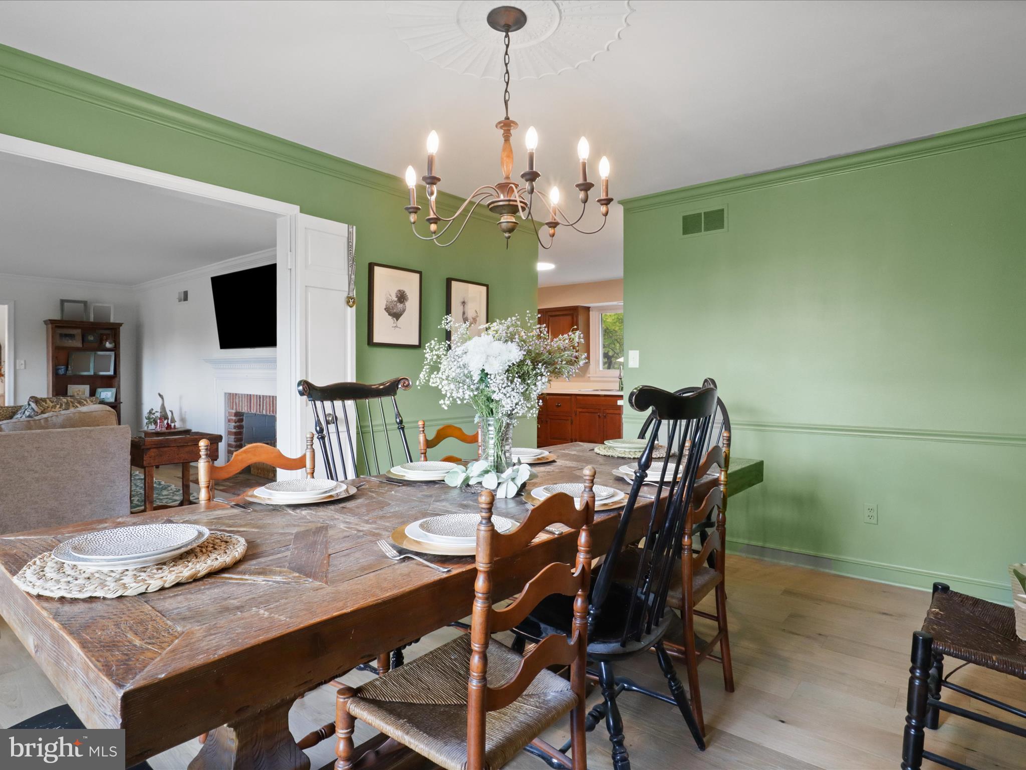 6811 White Rock Road Clifton, VA 20124 - Photo 19 of 87 a view of a dining room with furniture a chandelier and wooden floor