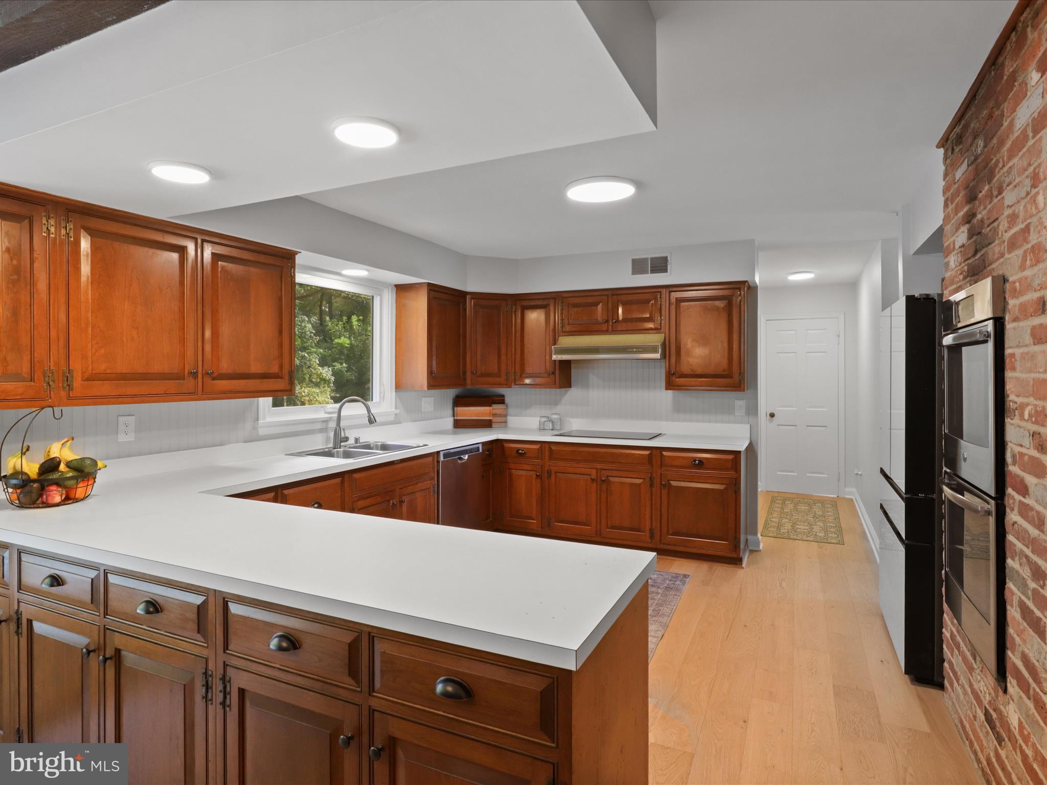 6811 White Rock Road Clifton, VA 20124 - Photo 25 of 87 a kitchen with stainless steel appliances granite countertop a sink a stove and a refrigerator