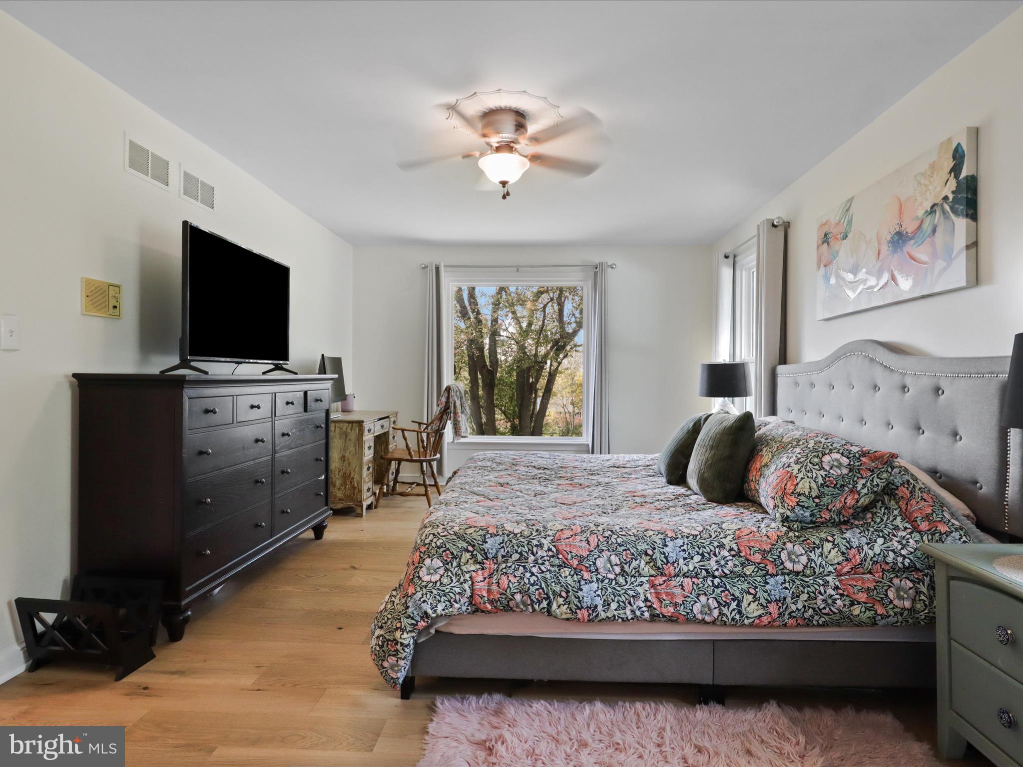 6811 White Rock Road Clifton, VA 20124 - Photo 46 of 87 a bedroom with a large bed and a flat tv screen on dresser
