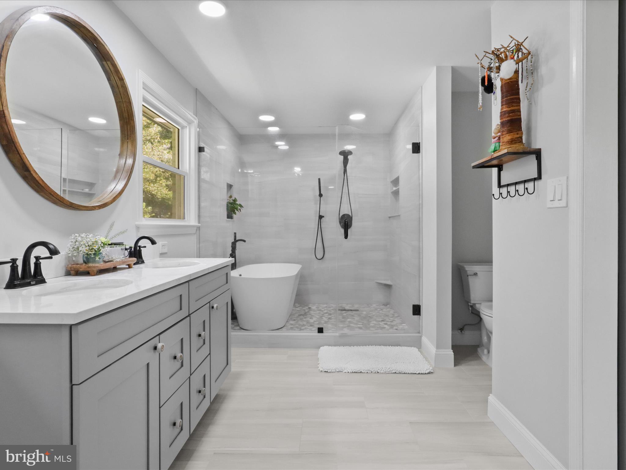 6811 White Rock Road Clifton, VA 20124 - Photo 49 of 87 a spacious bathroom with a double vanity sink mirror and shower