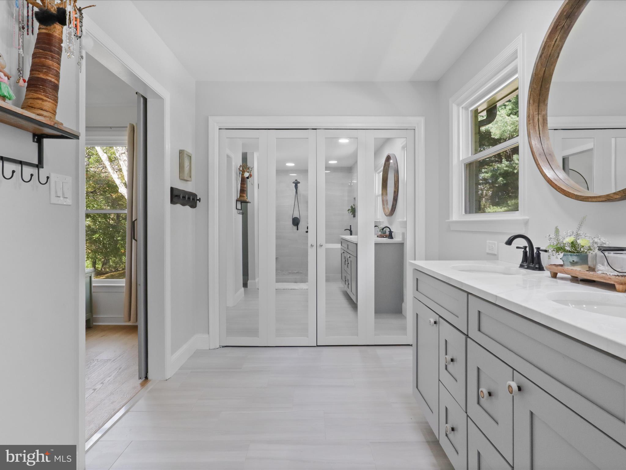 6811 White Rock Road Clifton, VA 20124 - Photo 52 of 87 a spacious bathroom with a double vanity sink a mirror a shower and a bathtub