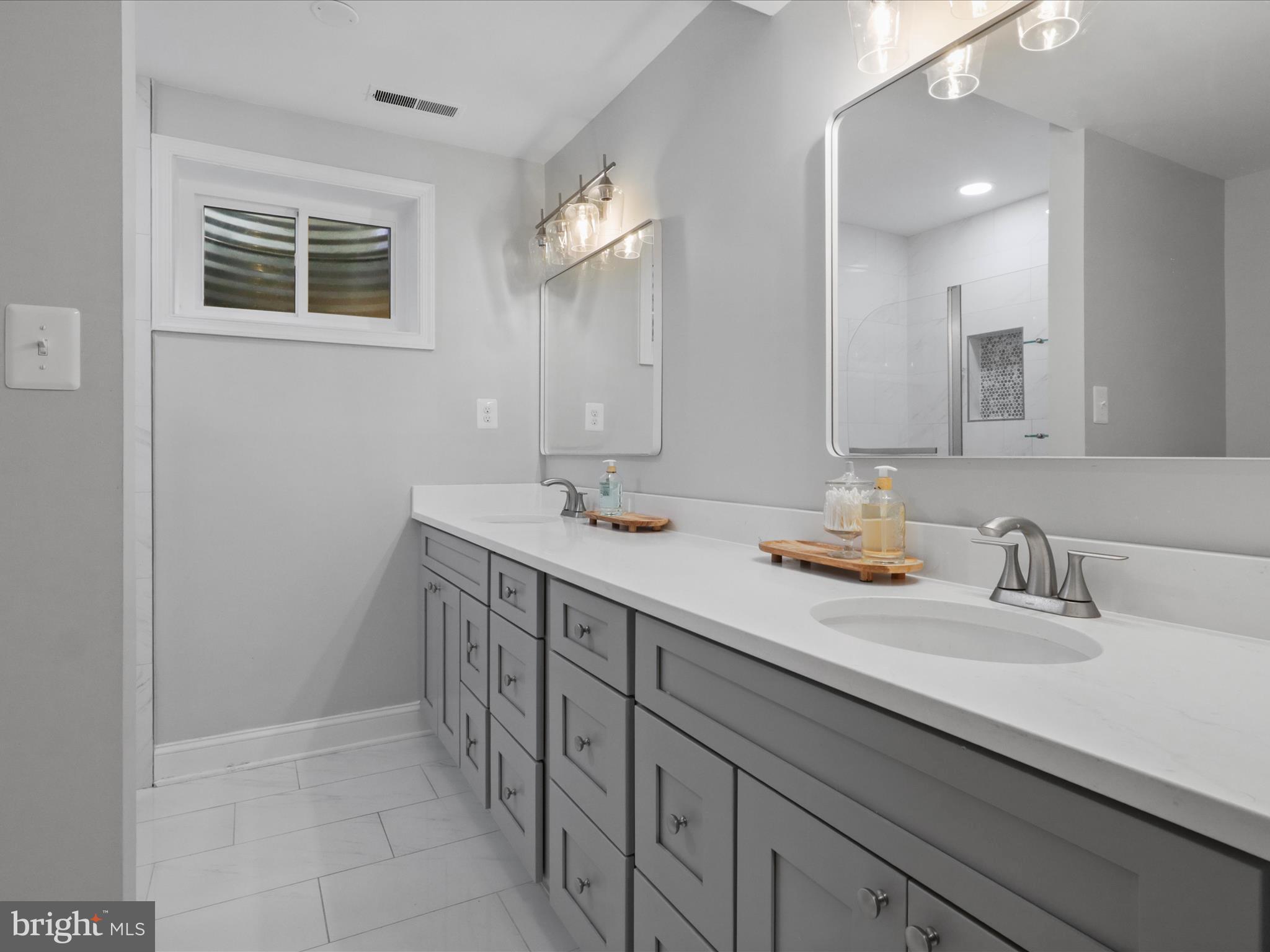 6811 White Rock Road Clifton, VA 20124 - Photo 60 of 87 a bathroom with a double vanity sink a mirror and a