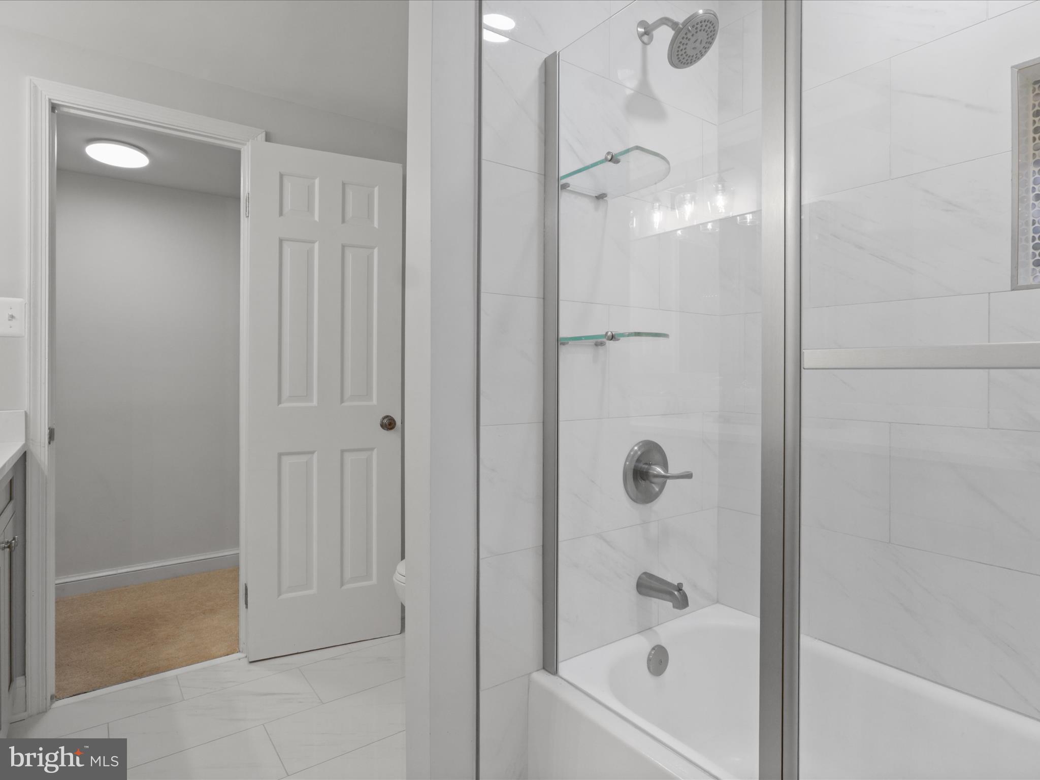 6811 White Rock Road Clifton, VA 20124 - Photo 61 of 87 a bathroom with a glass shower door
