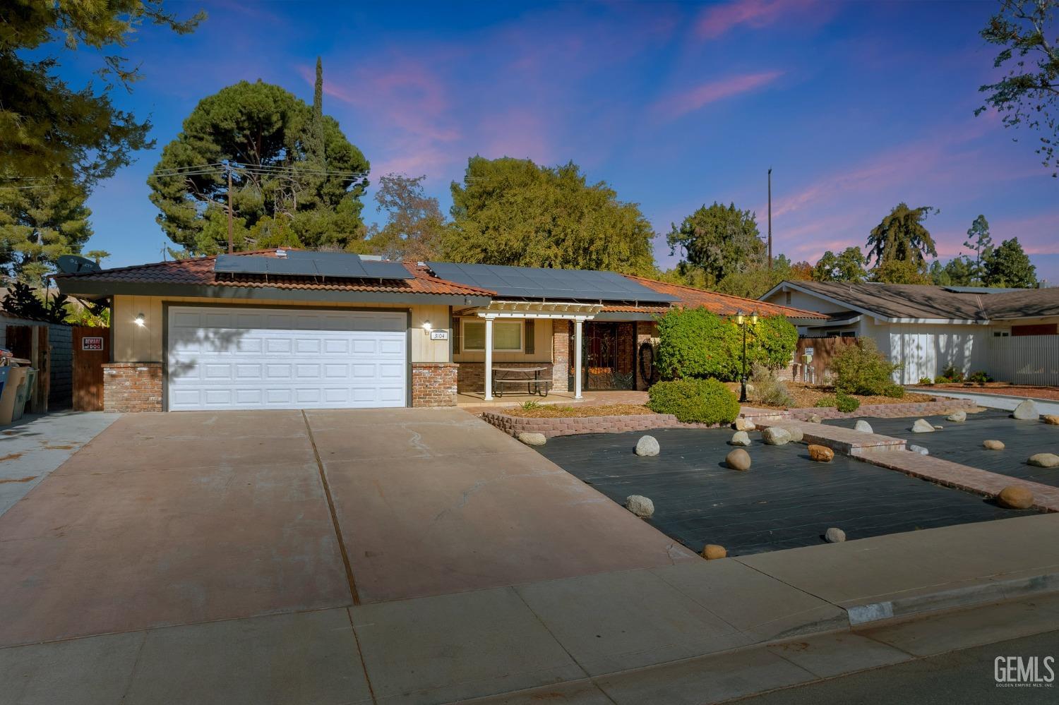 Undisclosed Address Bakersfield, CA 93306 - Photo 1 of 40 a front view of a house with a yard