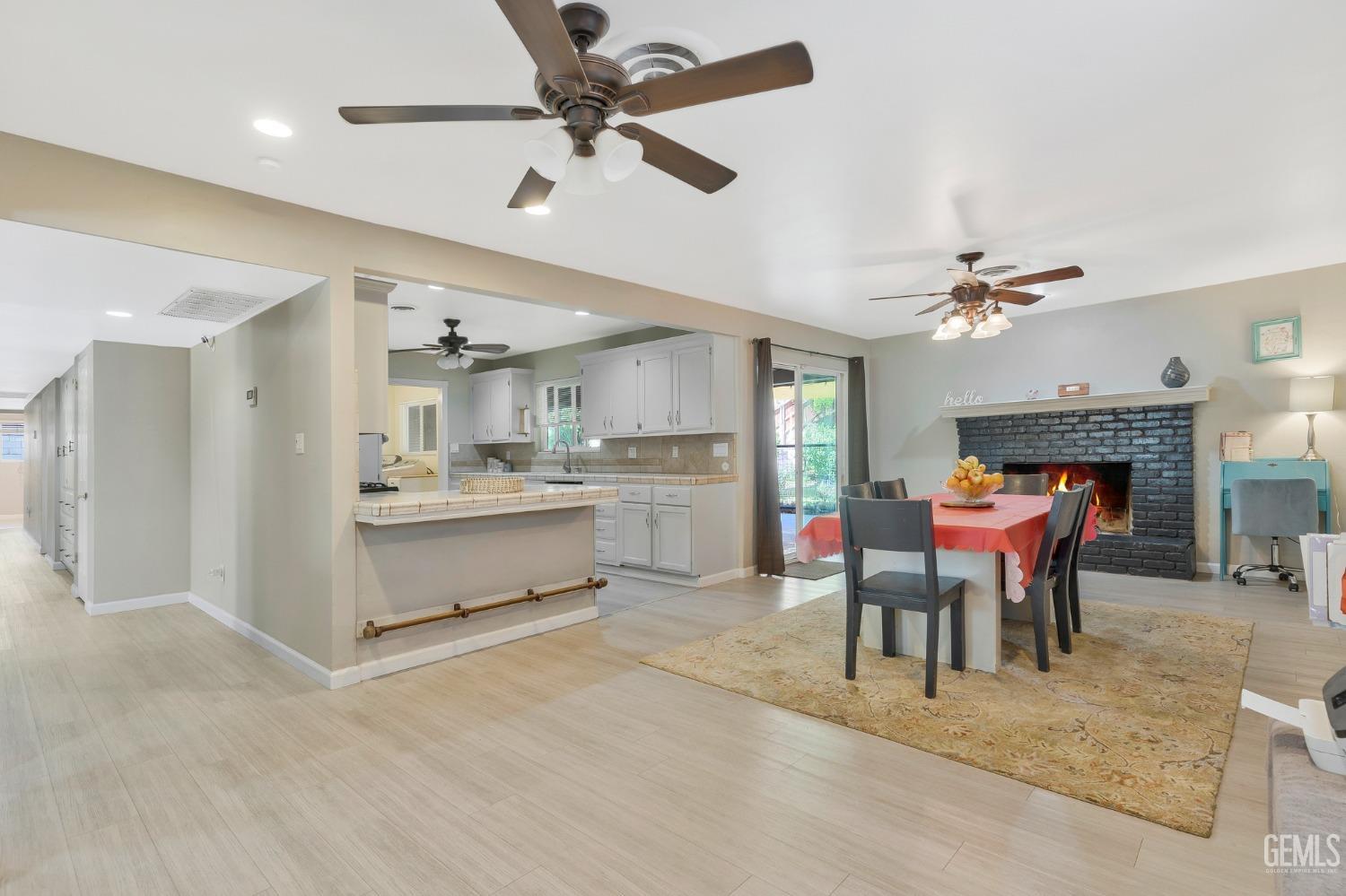 Undisclosed Address Bakersfield, CA 93306 - Photo 11 of 40 a dining room with a table chairs and a kitchen view