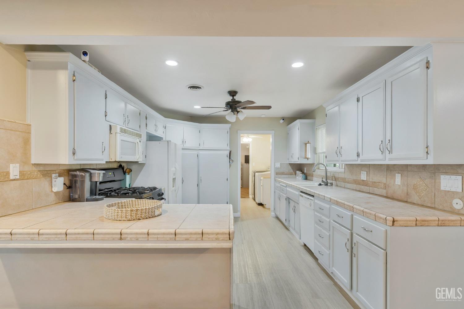 Undisclosed Address Bakersfield, CA 93306 - Photo 12 of 40 a view of a kitchen with kitchen island a sink stainless steel appliances and cabinets