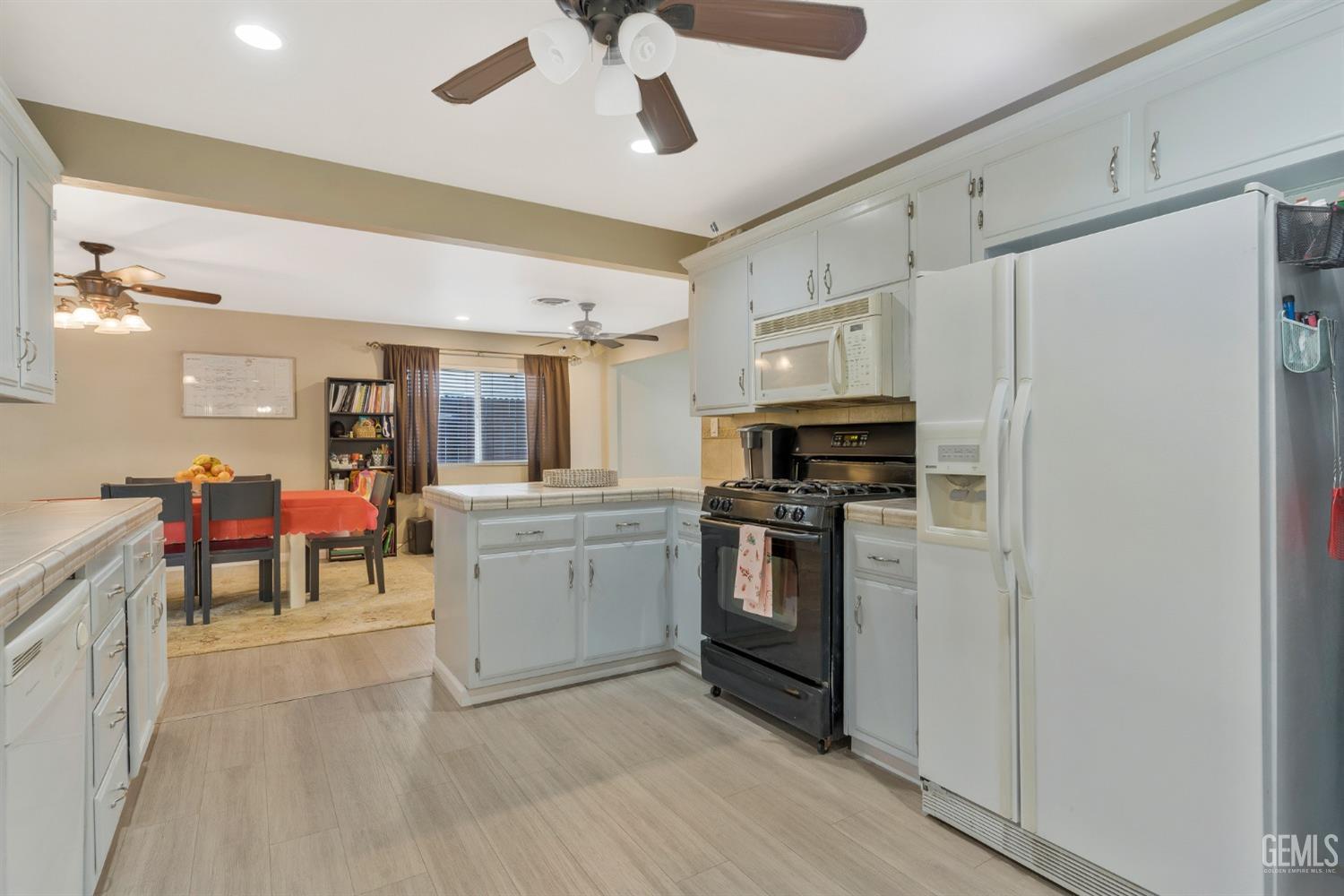 Undisclosed Address Bakersfield, CA 93306 - Photo 13 of 40 a kitchen with granite countertop a refrigerator stove top oven and sink