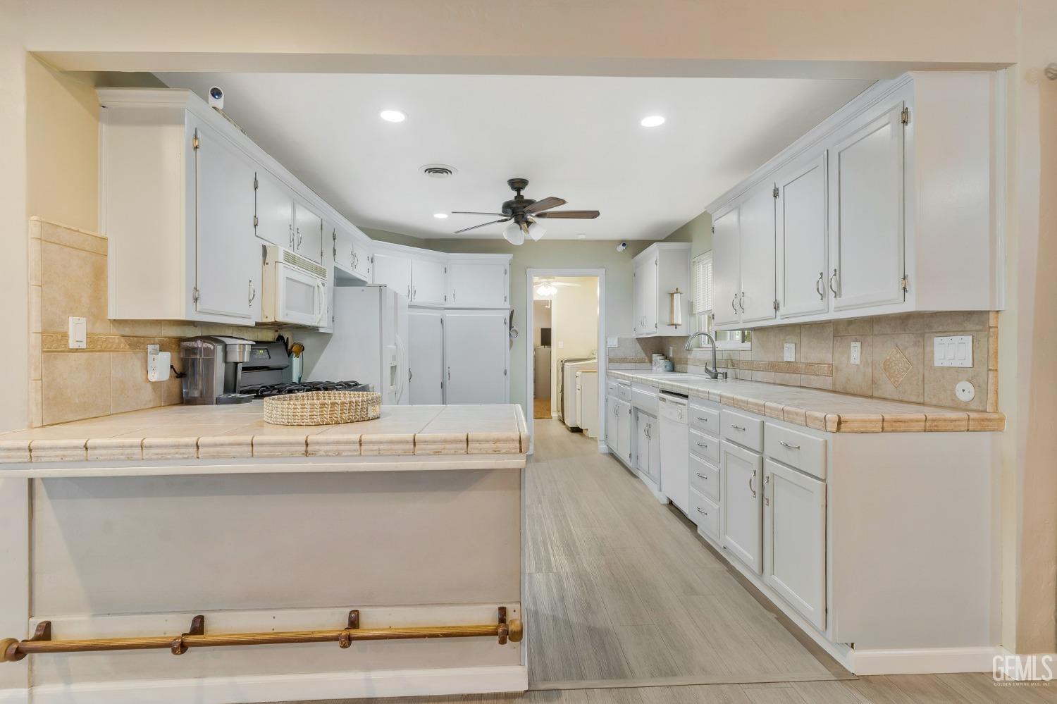 Undisclosed Address Bakersfield, CA 93306 - Photo 14 of 40 a kitchen with kitchen island sink stove and cabinets