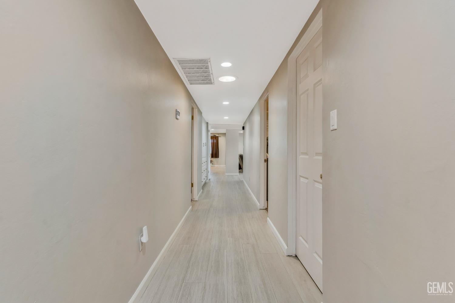 Undisclosed Address Bakersfield, CA 93306 - Photo 19 of 40 a view of a hallway with wooden floor