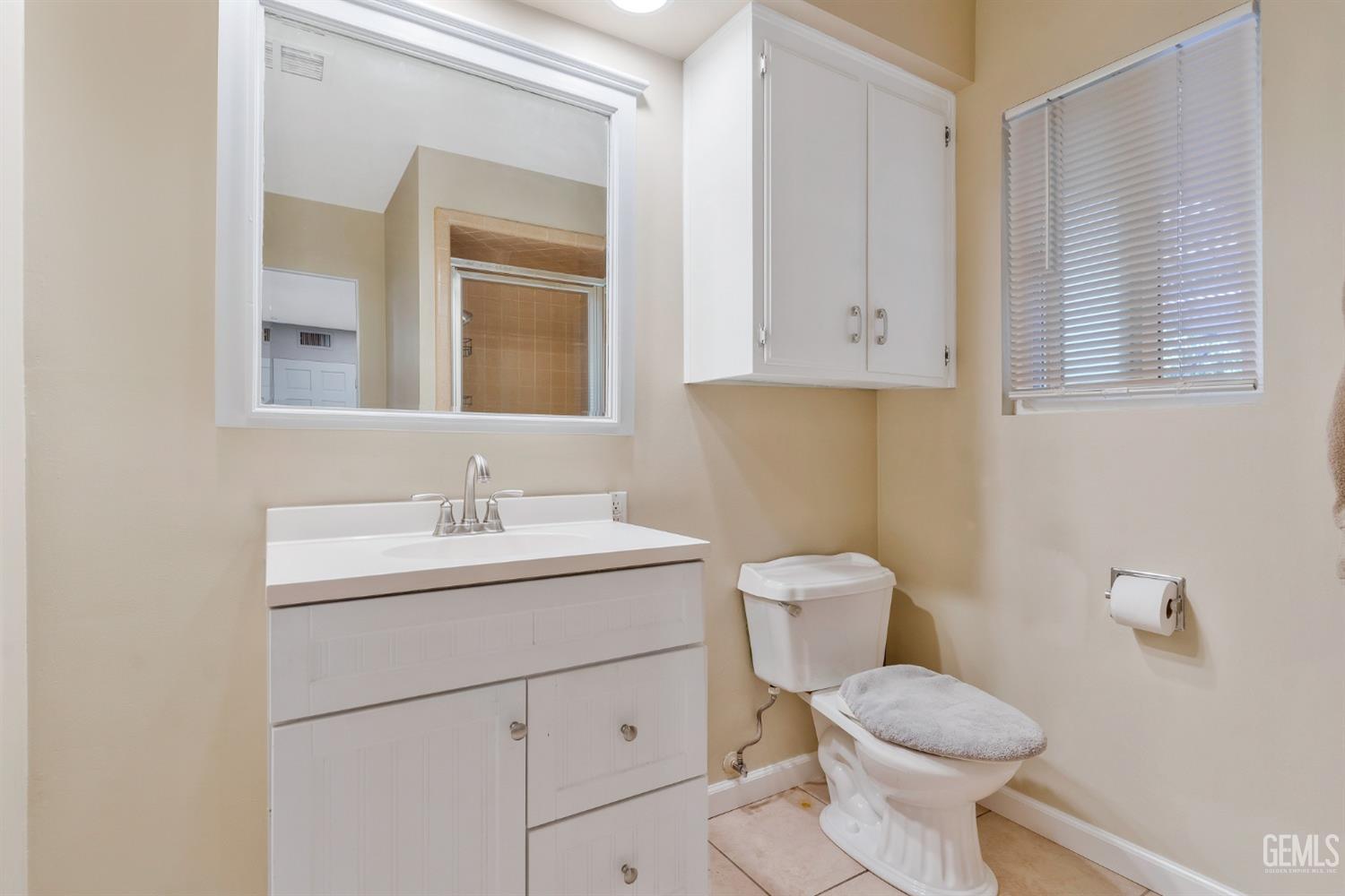 Undisclosed Address Bakersfield, CA 93306 - Photo 28 of 40 a bathroom with a toilet a sink and mirror