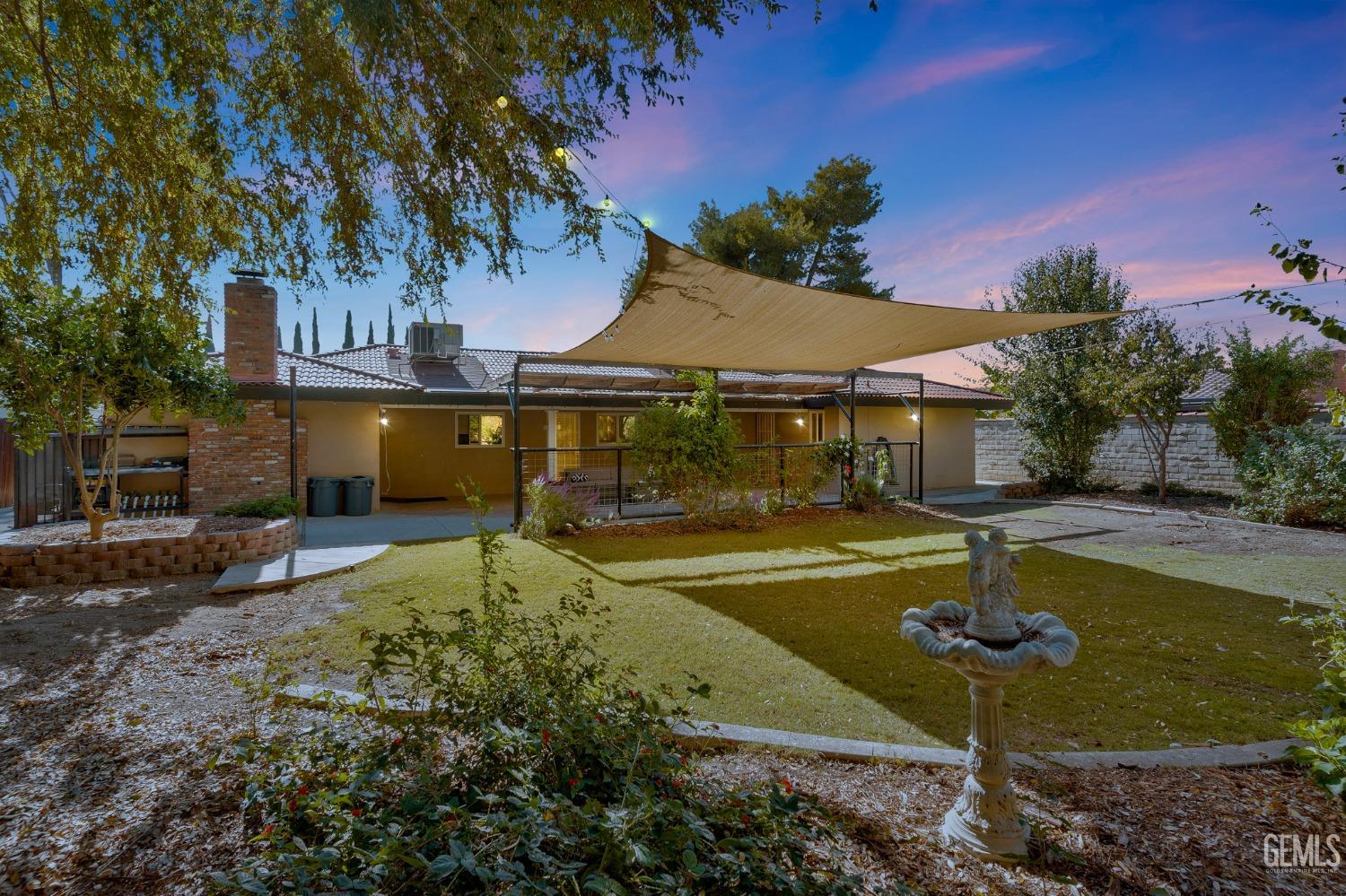 Undisclosed Address Bakersfield, CA 93306 - Photo 29 of 40 a view of a garden with a fountain