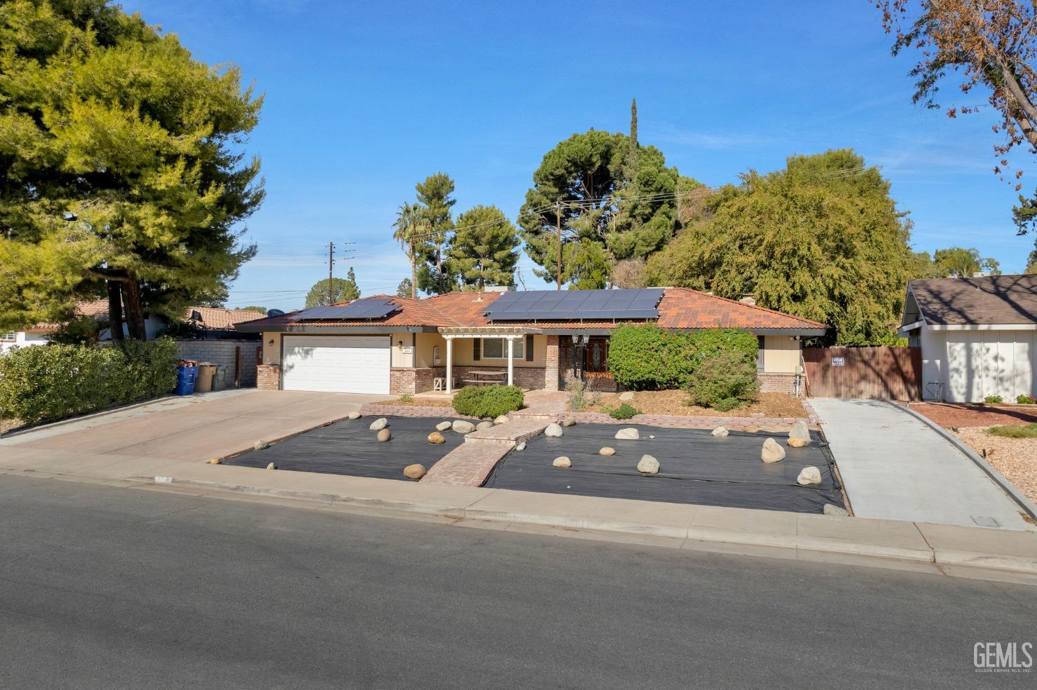 Undisclosed Address Bakersfield, CA 93306 - Photo 4 of 40 a front view of a house with yard