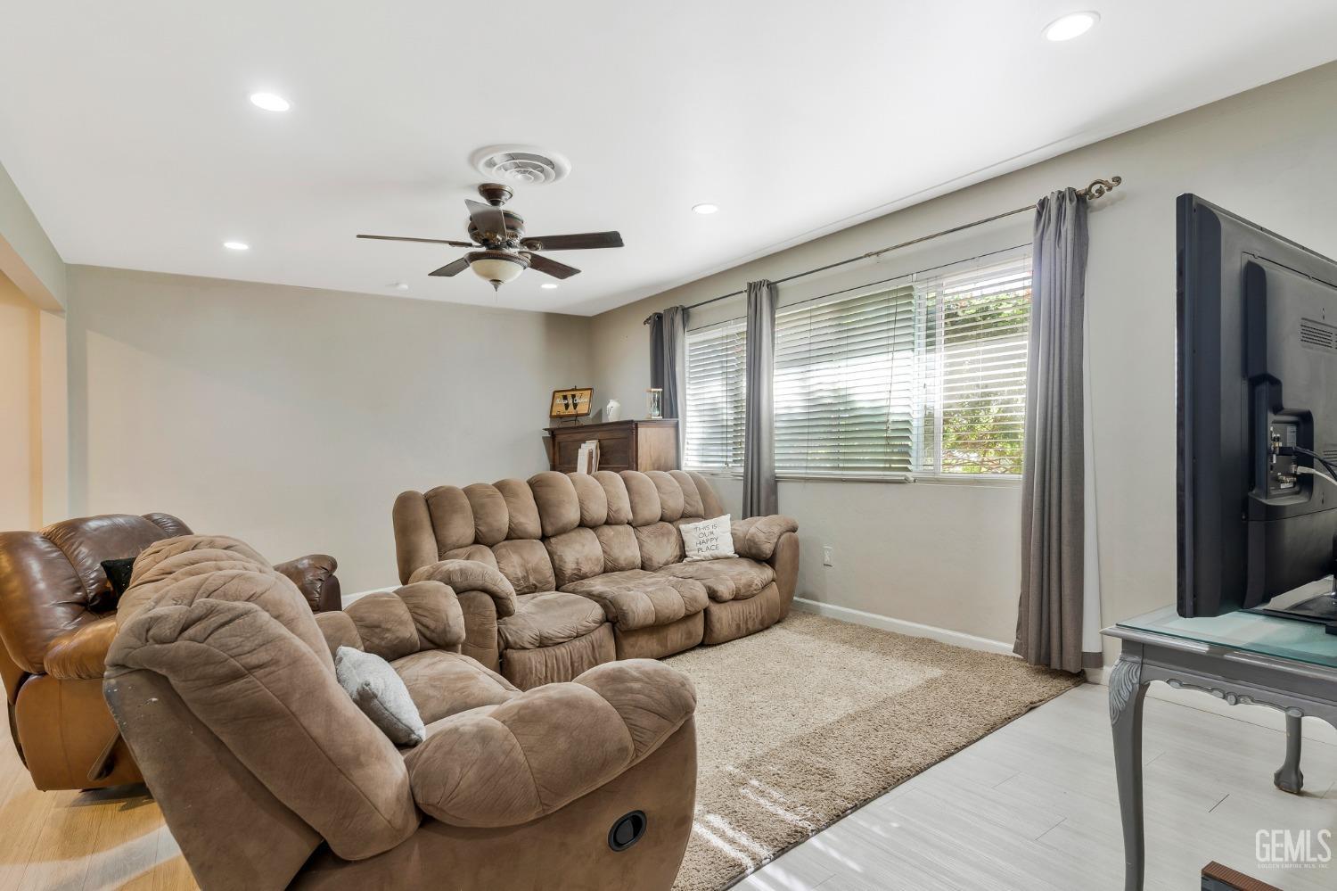 Undisclosed Address Bakersfield, CA 93306 - Photo 7 of 40 a living room with furniture ceiling fan and a rug