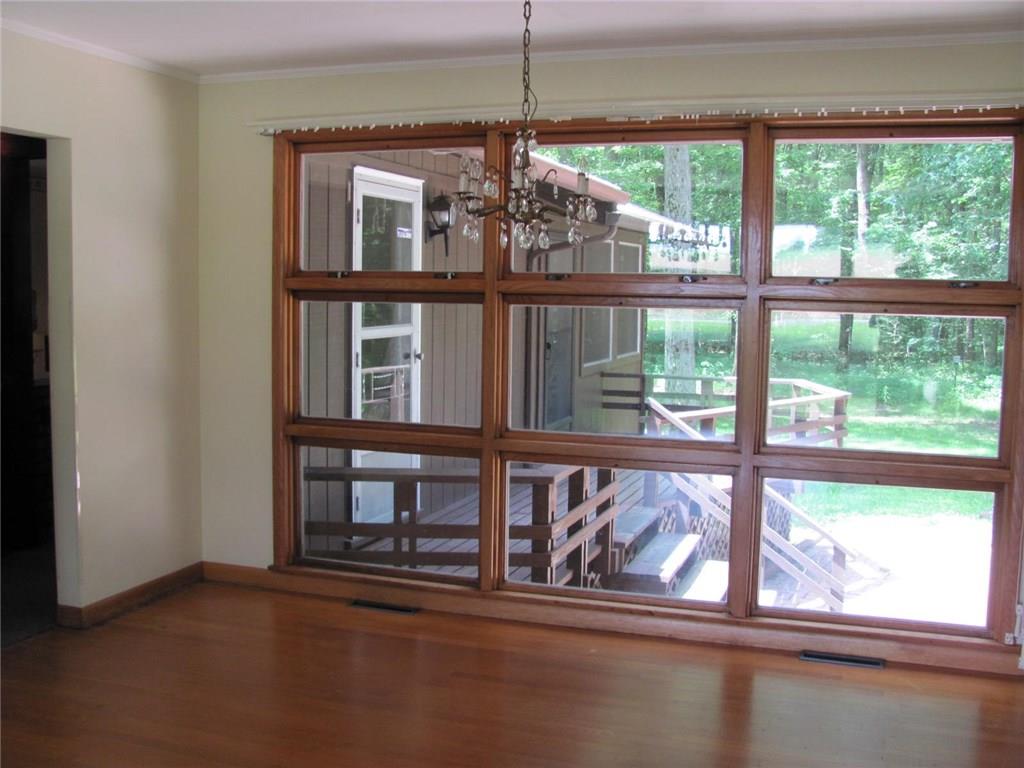 4989 Seneca Road Sharpsville, PA 16150 - Photo 10 of 19 Living room wall of windows to the backyard and deck