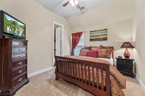 a bedroom with furniture and a flat screen tv