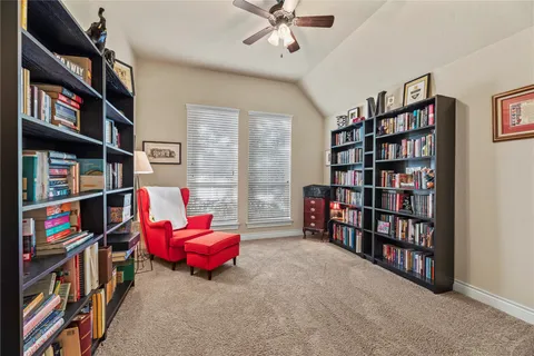 a living room with a book shelf and a book shelf