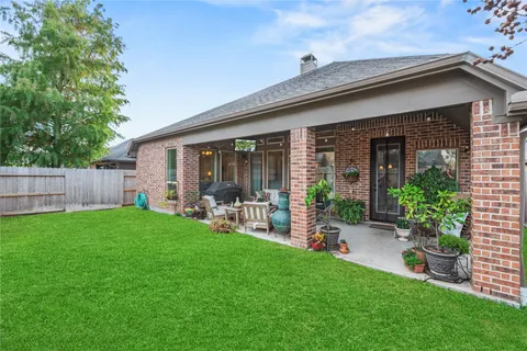 a view of an house with backyard space and garden