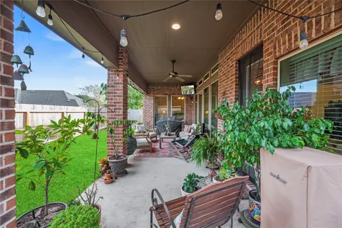 a view of a patio with plants and chairs