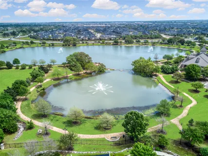 an aerial view of residential houses with outdoor space and lake view
