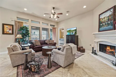 a living room with furniture fireplace and window