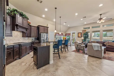 a kitchen with a table and chairs in it