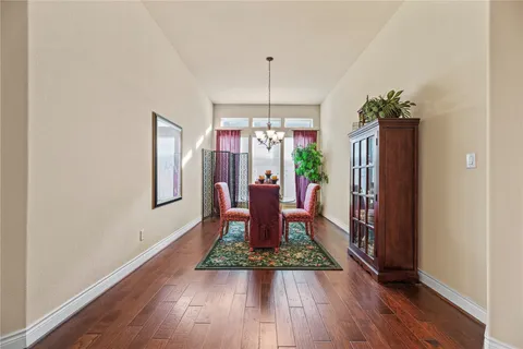 a dining room with furniture window and wooden floor