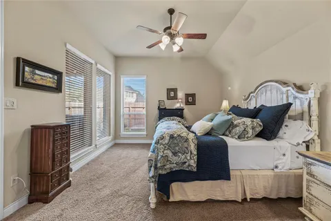 a bedroom with bed and balcony