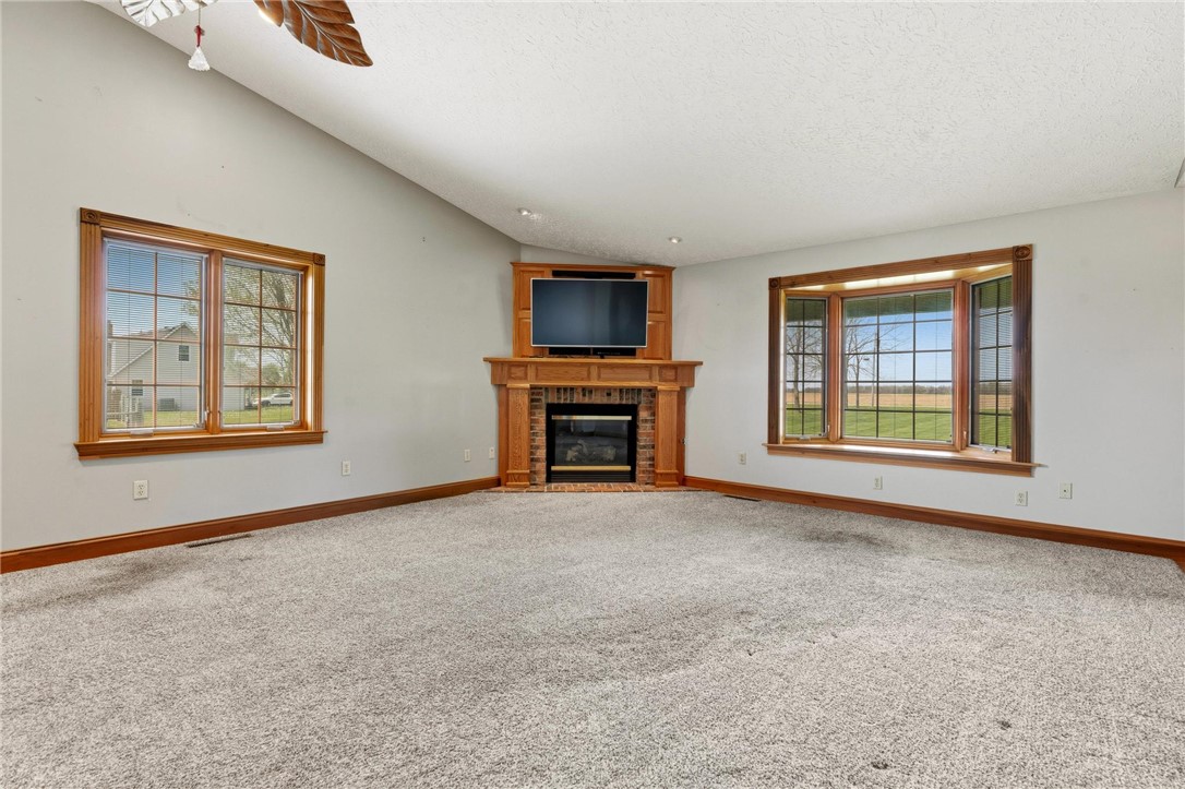 4971 Lackey Road Cedarville, OH 45314 - Photo 48 of 79 This inviting living space features vaulted ceilings, large windows, and a classic fireplace.