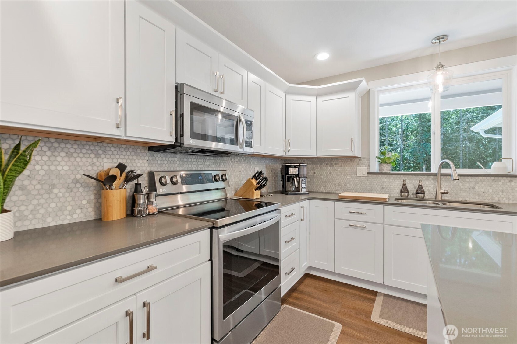 108 Timberline Lane Winlock, WA 98596 - Photo 10 of 20 a kitchen with granite countertop white cabinets stainless steel appliances a sink and a window