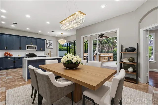 a large kitchen with stainless steel appliances granite countertop a large counter top and a view of living room