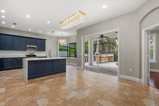 a kitchen with kitchen island a sink stainless steel appliances and cabinets