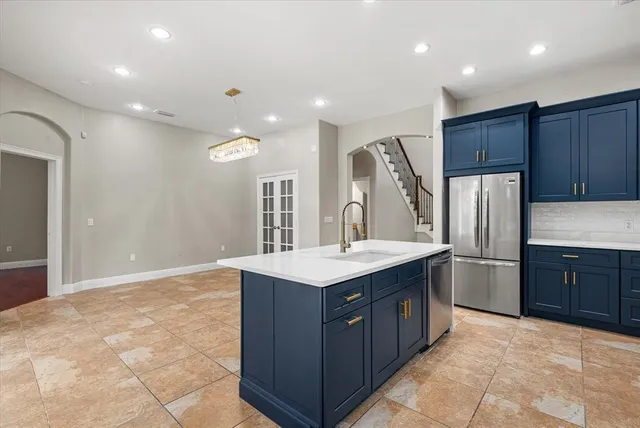 a kitchen with granite countertop wooden cabinets and stainless steel appliances