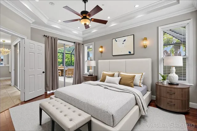 a view of an empty room with wooden floor and a ceiling fan