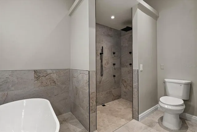 a bedroom with a bed and a potted plant