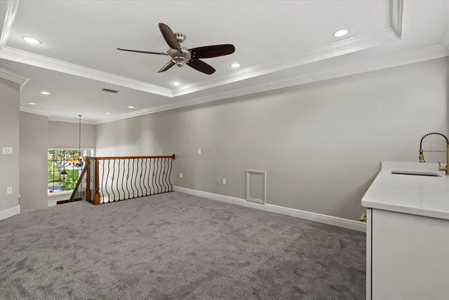 a spacious bedroom with a bed and a chandelier