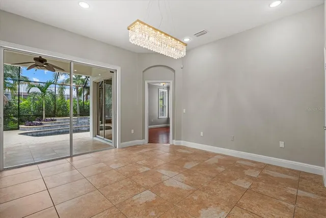 a view of a room with wooden floor and fan