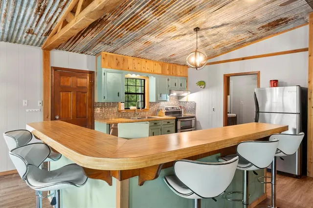 a dining room with furniture a chandelier and wooden floor