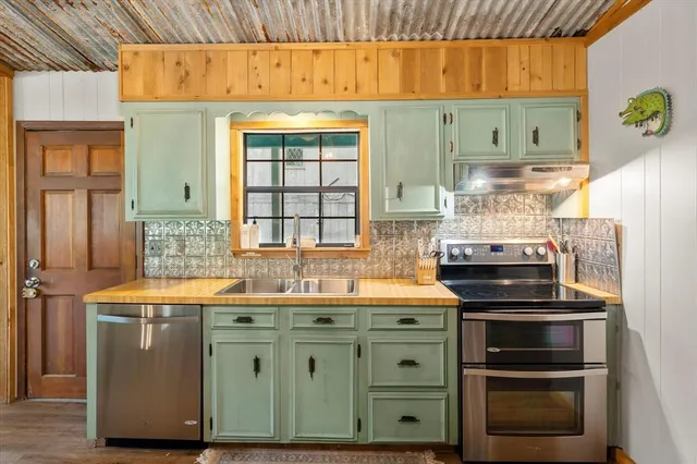 a kitchen with stainless steel appliances a stove and a refrigerator