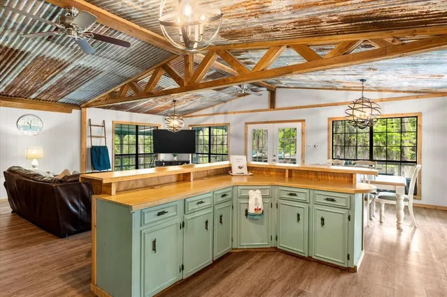 a kitchen with cabinets and wooden floor
