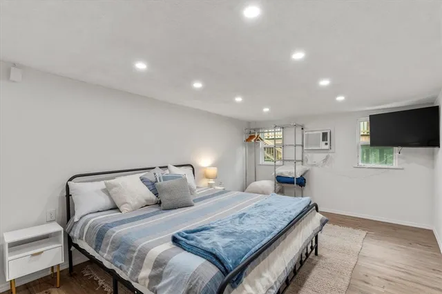 a bedroom with a bed and a flat screen tv