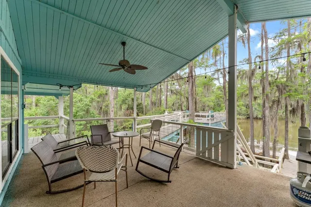 a balcony with furniture and a potted plant