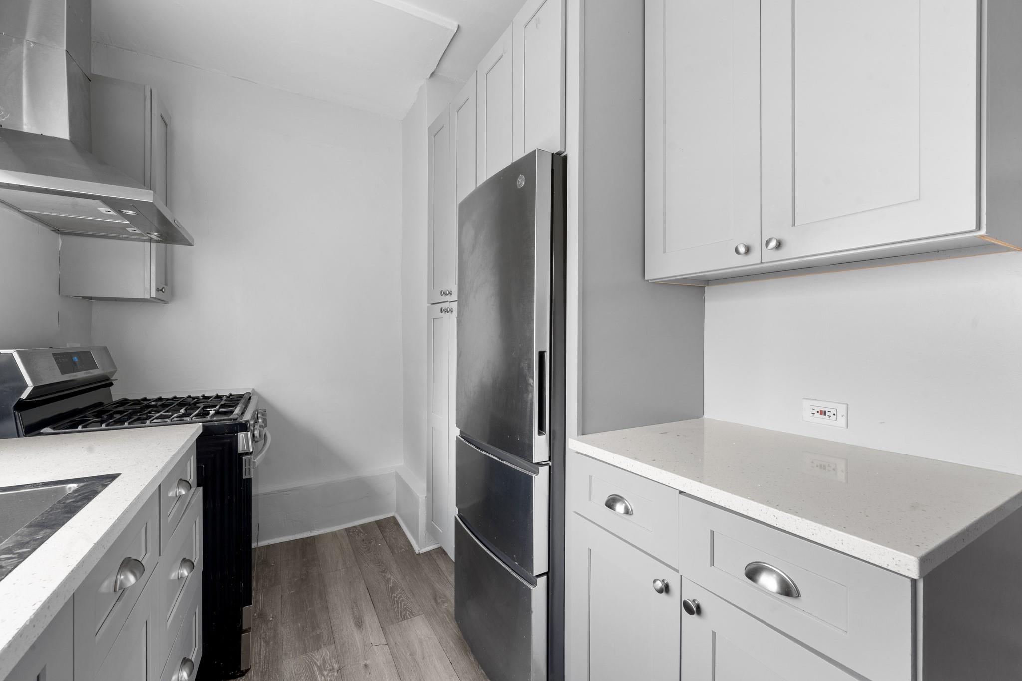 2445 Esplanade Bronx, NY 10469 - Photo 2 of 14 a kitchen with stainless steel appliances a stove and a refrigerator