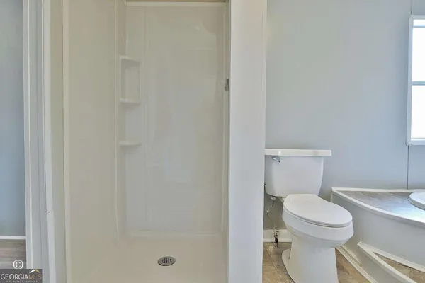 a white toilet sitting next to a bathroom sink