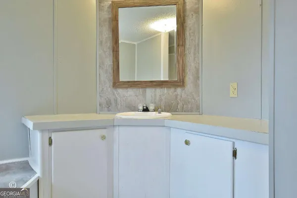a bathroom with a sink a vanity and a mirror