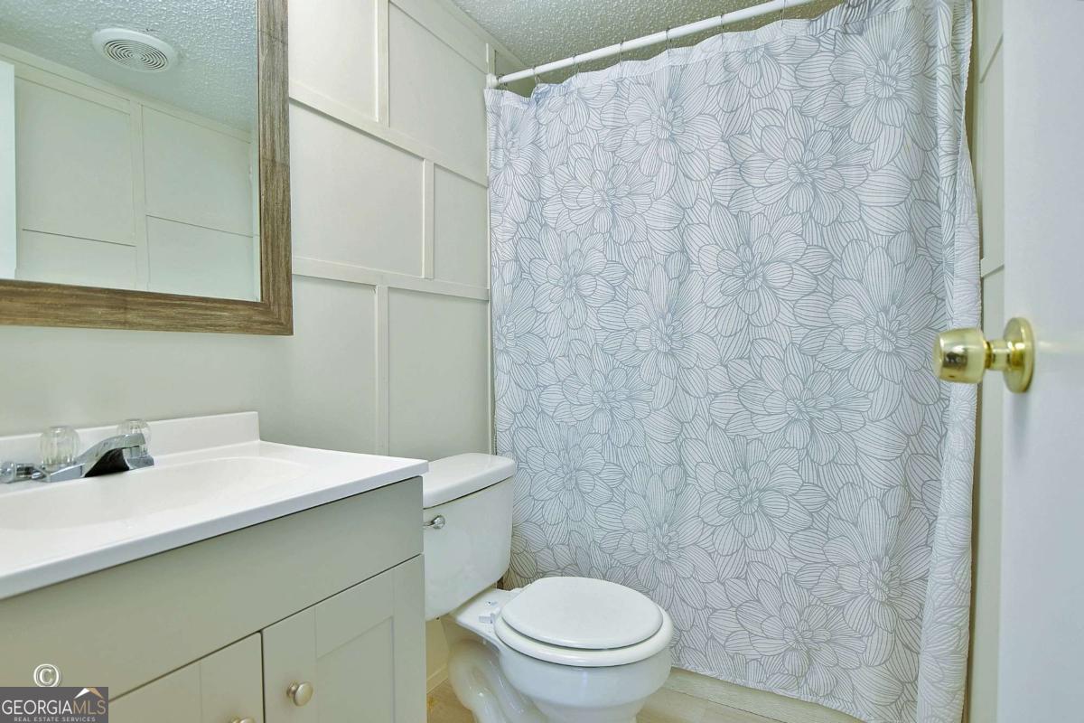 760 Hamilton Mulberry Grove Road Cataula, GA 31804 - Photo 20 of 26 a bathroom with a sink a toilet and shower