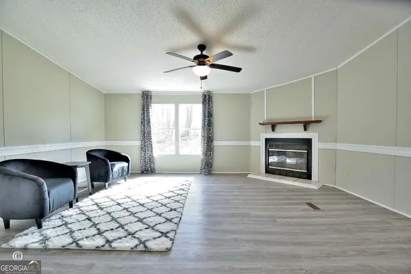 a bedroom with furniture and wooden floor