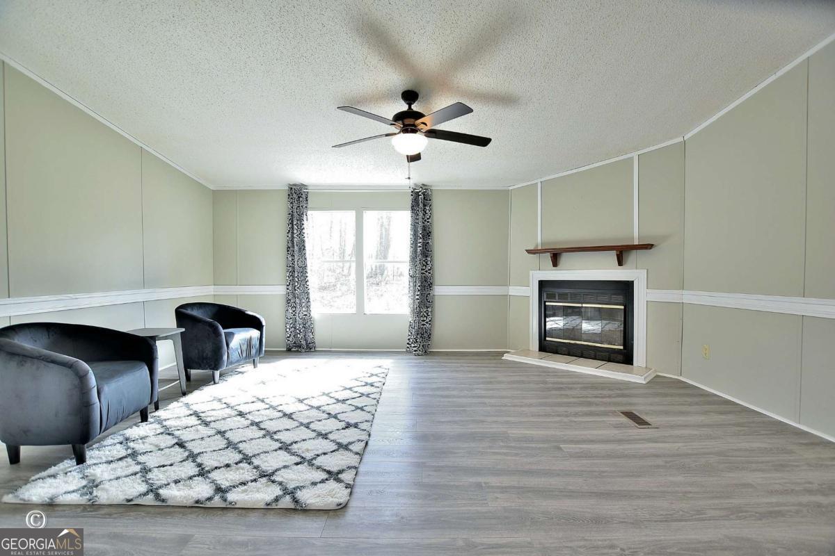 760 Hamilton Mulberry Grove Road Cataula, GA 31804 - Photo 2 of 26 a bedroom with furniture and wooden floor