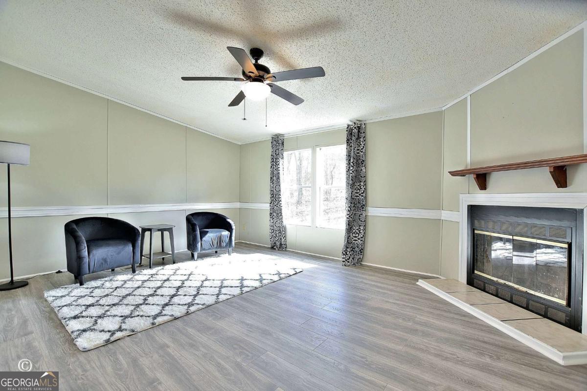 760 Hamilton Mulberry Grove Road Cataula, GA 31804 - Photo 3 of 26 a living room with furniture and a fireplace