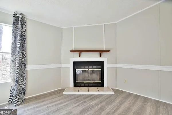 a living room with a fireplace and a window